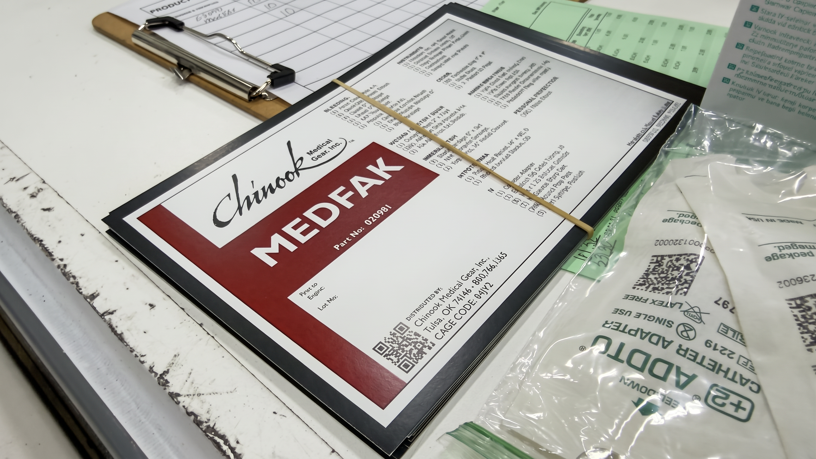 Chinook kit contents sheet beside packaged medical supplies and a clipboard
